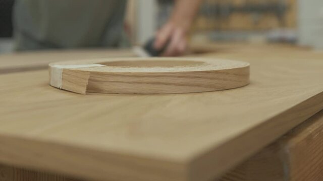 Roll of white oak veneer with carpenter sanding finished product