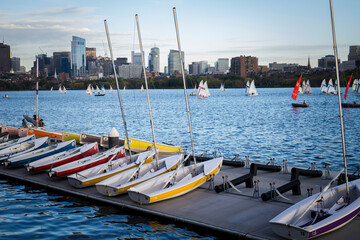 Docked sailing boats on a Charles River with view of Boston skyscrapers