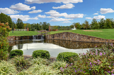 Fototapeta na wymiar Landscape with a pond encased stone on a gold course