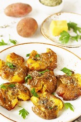 crushed potatoes. smashed potatoes. recipes for Australian cuisine. the potatoes are boiled in a shell, broken and baked in an oven with spices. 