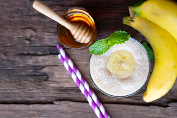 Banana fresh cocktail vanilla smoothies  fruit juice beverage healthy the taste yummy in glass drink episode good morning on wooden background from the top view.