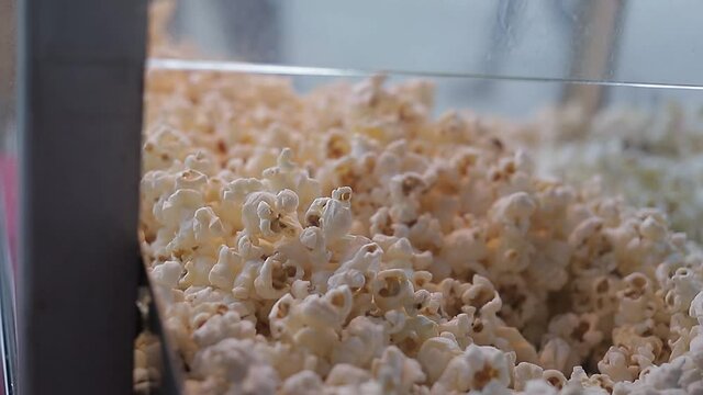 Piles of popcorn in display case, Shot shot with dolls.