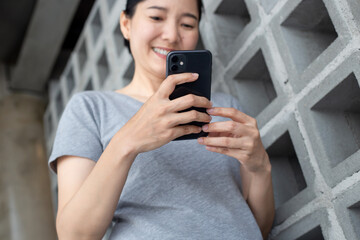 Fototapeta premium using cell phone hand holding mobile texting message contact us.chatting,search internet information in office.technology device communication connecting