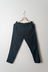 trousers or long pants hanging on wall