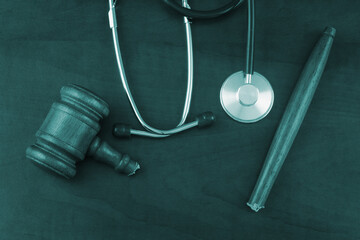 Broken wooden judge gavel and stethoscope, top view. Malpractice and careless concept