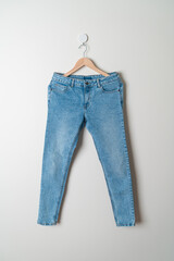 jeans trousers hanging on wall
