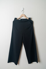 trousers or long pants hanging on wall