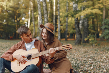 Fototapeta premium Beautiful couple spend time in a autumn park
