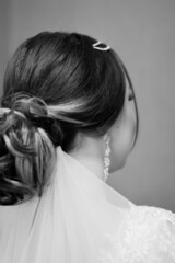 bride's hairstyle. bun and white veil. beautiful bride. wedding day.