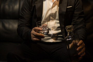 Businessmen in suits drinking whiskey