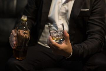 Businessmen in suits drinking whiskey