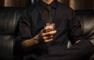 Businessmen in suits drinking whiskey