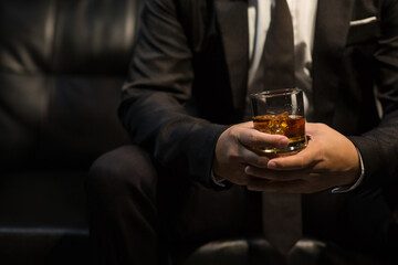 Businessmen in suits drinking whiskey