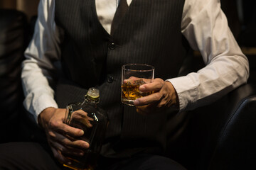 Businessmen in suits drinking whiskey