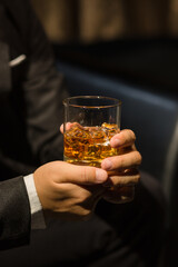 Businessmen in suits drinking whiskey