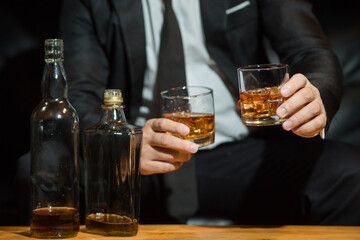 Businessmen in suits drinking whiskey