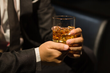 Businessmen in suits drinking whiskey