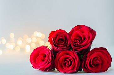 Selective focus of red roses on white background with bokeh light for anniversary, mother and Valentine's day concept.