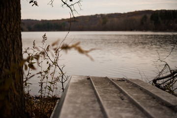 Upturned metal fishing boat on shore by river