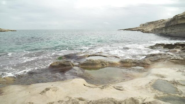 Mediterranean Sea Washes Shores of Stone Beach Il-Kalanka in Malta