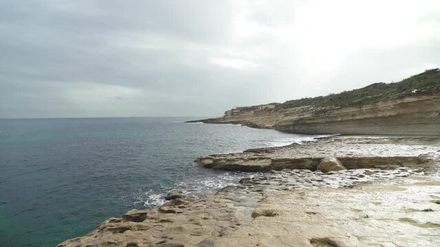 Shallow Water Washes the Shore of Stone Beach Il-Kalanka in Malta