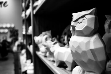 Row of blank unfinished ceramic figures on a studio shelf in a DIY store for painting. 