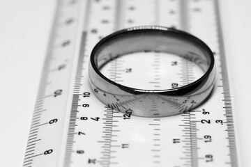 A gold ring on a ruler, a measuring tool in a pawnshop, determining the size of jewelry