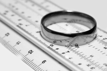 A gold ring on a ruler, a measuring tool in a pawnshop, determining the size of jewelry