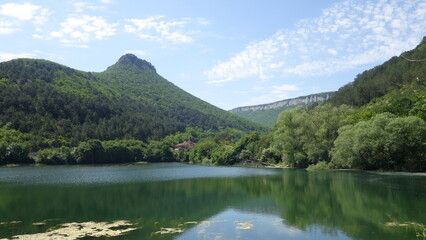 Fototapeta premium Green mountains on the lake shore, Mangup-kale