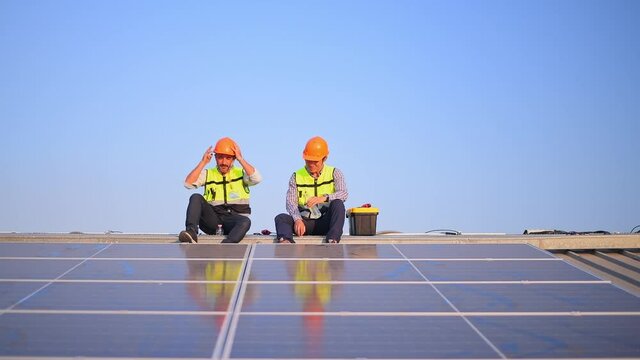 Engineer wearing unifrom and helmet inspect and check solar cell panel ,solar cell is ecology energy sunlight power installation for industrail ,alternative environment power concept.	

