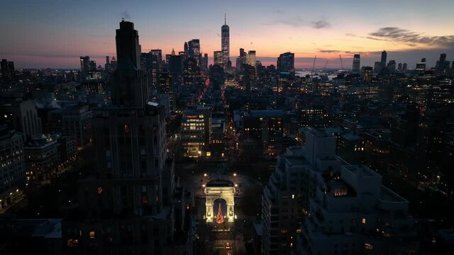 sunset flying over Washington Square Park towards downtown NYC