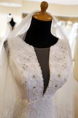 Beautiful white wedding dress gown on mannequin in boutique