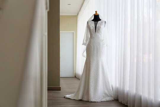Beautiful white wedding dress gown on mannequin in boutique