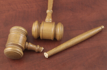 Court and laws changing concept. Two judge gavels, one wooden gavel broken.
