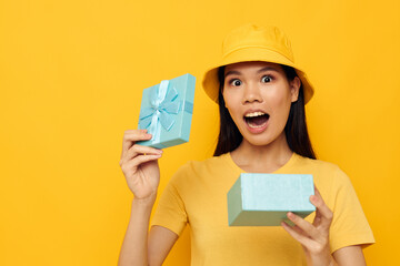 pretty brunette with a gift box in his hands surprise emotions isolated background unaltered