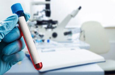 Doctor in the lab holding tubes of blood. Laboratory Technician with blood samples with a New...