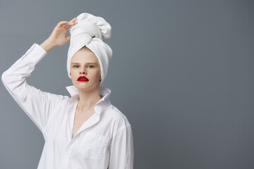 fashionable woman white shirt cosmetics with towel on head studio model unaltered