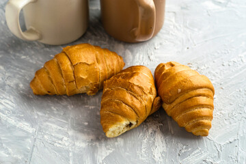 coffee mugs and croissants on the table