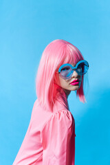 woman in blue glasses wears a pink wig Lifestyle posing