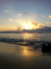 Fototapeta na wymiar Golden sunrise over the beach
