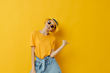 young woman fashion in yellow t-shirt posing fashion in panama yellow background