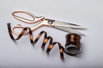 sewing scissors, brown braid, ribbon on a white background