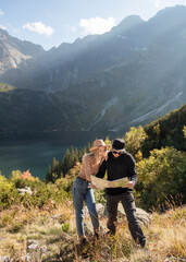Fototapeta na wymiar Young tourist couple, man and woman, on hiking path in mountains