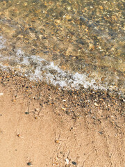surf on the beach, sandy beach with pebbles