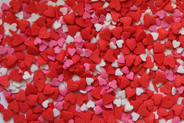 sprinkle hearts on a white background with a place for text