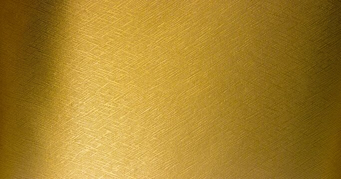 Background image of a textured silver background changing to gold.