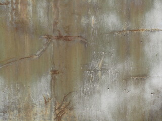 Rusty scratched metal surface. Faded painted wall of an old abandoned building. Close-up....