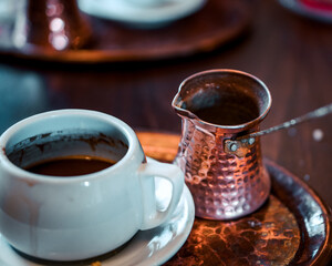 traditional Greek coffee served with the traditional pot on the table  