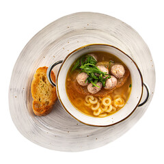 Isolated portion of anelli soup with chicken meatballs