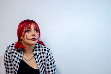 Teen girl put on make-up for a masquerade ball and made a modern hairstyle 